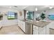 Bright kitchen featuring a large island, stainless steel appliances, and granite countertops at 5916 Wake Forest Run # 101, Bradenton, FL 34211