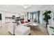 Bright open-concept living room featuring an updated kitchen, patio access and view at 5916 Wake Forest Run # 101, Bradenton, FL 34211