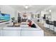 Open-concept living room with dining area, kitchen, tile floors, and bright decor at 5916 Wake Forest Run # 101, Bradenton, FL 34211