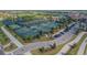 Aerial view of the tennis courts at this amazing community, complete with tennis players and covered areas at 5916 Wake Forest Run # 101, Bradenton, FL 34211