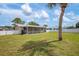 Enjoy a large grassy backyard, privacy fence, screened in patio, and beautiful mature trees at 609 Carmel Rd, Venice, FL 34293
