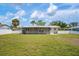 Expansive backyard featuring a screened-in lanai, perfect for outdoor living and entertaining with a well manicured yard at 609 Carmel Rd, Venice, FL 34293