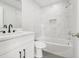 The bathroom is modernized with marble-like tiling, sleek fixtures, and a shower-tub combination at 609 Carmel Rd, Venice, FL 34293