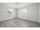 This bedroom features sleek gray flooring and two bright windows for natural light at 609 Carmel Rd, Venice, FL 34293