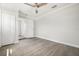 Bright bedroom featuring light gray flooring, a modern ceiling fan, and a closet; access to an updated ensuite bathroom at 609 Carmel Rd, Venice, FL 34293