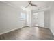 Well-lit bedroom with light gray flooring, a ceiling fan, closet, and a window offering natural light at 609 Carmel Rd, Venice, FL 34293