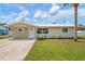 Charming single-story home with well-maintained lawn and modern landscaping, complemented by a clean, concrete driveway at 609 Carmel Rd, Venice, FL 34293
