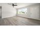 Bright and airy living room with light gray flooring, ceiling fan, and a large window providing ample natural light at 609 Carmel Rd, Venice, FL 34293