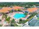 Aerial view showcasing a community pool, clubhouse, and lush landscaping at 6312 41St E Ct, Sarasota, FL 34243