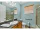 Bathroom featuring granite countertops, a sink, a vanity, and a glass door shower at 6312 41St E Ct, Sarasota, FL 34243