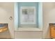 Bathroom with a soaking tub, tile flooring, and a window allowing natural light at 6312 41St E Ct, Sarasota, FL 34243