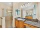 Bathroom featuring granite countertops, a sink, a vanity, and a glass door shower at 6312 41St E Ct, Sarasota, FL 34243