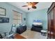 Bedroom featuring a desk, TV, and armoire, providing a functional living space at 6312 41St E Ct, Sarasota, FL 34243