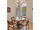 Cozy breakfast nook with a round table, four chairs and plenty of natural light at 6312 41St E Ct, Sarasota, FL 34243