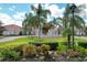 Beautiful clubhouse with water fountain, palm trees, meticulously manicured grounds, and inviting architecture at 6312 41St E Ct, Sarasota, FL 34243