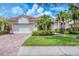 Charming single-story home featuring a lush lawn, red tile roof and a brick driveway at 6312 41St E Ct, Sarasota, FL 34243