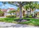 Beautiful home with a well-maintained lawn, mature trees, and tropical landscaping at 6312 41St E Ct, Sarasota, FL 34243