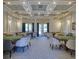 Clubhouse card room featuring multiple card tables, comfortable seating, and elegant decor at 6312 41St E Ct, Sarasota, FL 34243