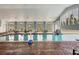 Bright indoor pool with large windows and ample seating, perfect for year-round enjoyment at 6312 41St E Ct, Sarasota, FL 34243