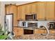 Well-equipped kitchen featuring stainless steel appliances, granite countertops, and wooden cabinetry at 6312 41St E Ct, Sarasota, FL 34243