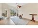 Bright living room with tile floors, ceiling fan and glass sliding door to backyard at 6312 41St E Ct, Sarasota, FL 34243