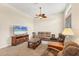 Open-concept living room with a ceiling fan and a comfortable seating arrangement at 6312 41St E Ct, Sarasota, FL 34243