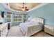 Inviting main bedroom with large windows, tray ceiling, and a ceiling fan at 6312 41St E Ct, Sarasota, FL 34243