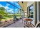 Enjoy outdoor bliss on a screened patio with scenic views and comfortable seating area at 6312 41St E Ct, Sarasota, FL 34243
