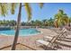 Beautiful outdoor pool surrounded by lounge chairs and lush greenery, creating a resort-like atmosphere at 6312 41St E Ct, Sarasota, FL 34243