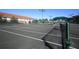 Well-maintained tennis court featuring a net and clear court lines and green net posts at 6312 41St E Ct, Sarasota, FL 34243