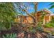 Inviting backyard featuring tropical foliage, garden beds, and a charming swing for relaxing outdoors at 6806 Palm Dr, Holmes Beach, FL 34217