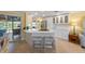 Open kitchen with white cabinets, stainless steel appliances, and a breakfast bar with seating at 6806 Palm Dr, Holmes Beach, FL 34217