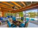 Comfortable screened-in lanai overlooking the water and kayaks with ample seating and dining area at 6806 Palm Dr, Holmes Beach, FL 34217