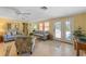 Cozy living room with comfortable seating, neutral decor, and access to the outdoors at 6806 Palm Dr, Holmes Beach, FL 34217