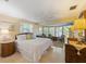 Comfortable main bedroom with neutral tones, a bay window seating area, and ample natural light at 6806 Palm Dr, Holmes Beach, FL 34217