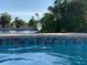 Inviting pool view featuring shimmering water, mosaic tiles, and a serene backdrop at 6806 Palm Dr, Holmes Beach, FL 34217