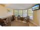 Sitting area with comfortable chairs, a desk, and natural light from the surrounding windows at 6806 Palm Dr, Holmes Beach, FL 34217