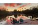 Inviting water view featuring dock, chairs and serene water reflections at sunset at 6806 Palm Dr, Holmes Beach, FL 34217