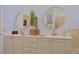 Double sink vanity with framed mirrors, decorative accessories, and storage space at 695 Rivendell Blvd, Osprey, FL 34229
