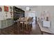Elegant dining room features hardwood floors, a built-in bookcase, and sliding doors leading to a lanai at 695 Rivendell Blvd, Osprey, FL 34229