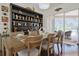 Stylish dining area featuring hardwood floors, a rustic table set, and sliding doors opening to the outdoors at 695 Rivendell Blvd, Osprey, FL 34229