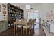 Charming dining room with hardwood floors, large bookcase, sliding doors, and a rustic dining set at 695 Rivendell Blvd, Osprey, FL 34229