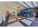 Spacious garage featuring a custom-designed floor and ample storage space for vehicles and equipment at 695 Rivendell Blvd, Osprey, FL 34229