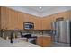 A well-appointed kitchen features wood cabinets and stainless steel appliances at 695 Rivendell Blvd, Osprey, FL 34229