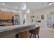 Kitchen featuring a breakfast bar and modern stainless steel refrigerator at 695 Rivendell Blvd, Osprey, FL 34229