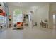 Inviting living room with retro decor, transom windows, tile floors, and comfortable seating arrangement at 695 Rivendell Blvd, Osprey, FL 34229