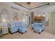 Open concept living room featuring light blue furniture and adjacent kitchen at 695 Rivendell Blvd, Osprey, FL 34229