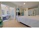 A view of this main bedroom shows light-filled space and sliders to the lanai at 695 Rivendell Blvd, Osprey, FL 34229