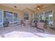 Screened patio with ceiling fan, seating area, and views to interior at 695 Rivendell Blvd, Osprey, FL 34229