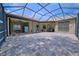 Spacious screened-in patio featuring brickwork and a view of the home's exterior at 695 Rivendell Blvd, Osprey, FL 34229